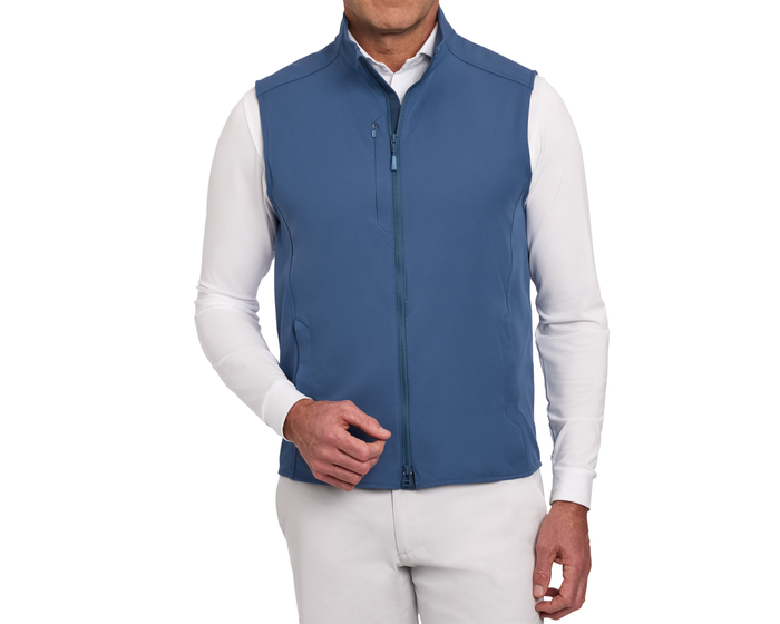 The Boyd Vest: Andover - zip-front, sleeveless, windproof, water-resistant vest with stand collar and pockets, worn over a long-sleeve shirt and trousers.