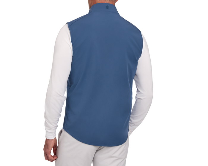 Back view of a model wearing The Boyd Vest: Andover, a sleek windbreaker vest over a long-sleeve shirt, highlighting its lightweight, windproof, and water-resistant features.