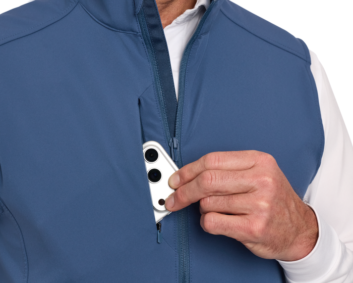 The Boyd Vest: Andover shown with a zippered chest pocket, easily storing a smartphone, highlighting its windproof, water-resistant, and stretchy design for versatile use.