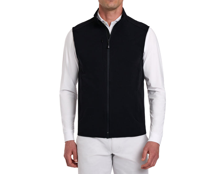 Model in The Boyd Vest: Black, a sleeveless, windproof, and water-resistant vest with a two-way zipper, over a long-sleeve white shirt.