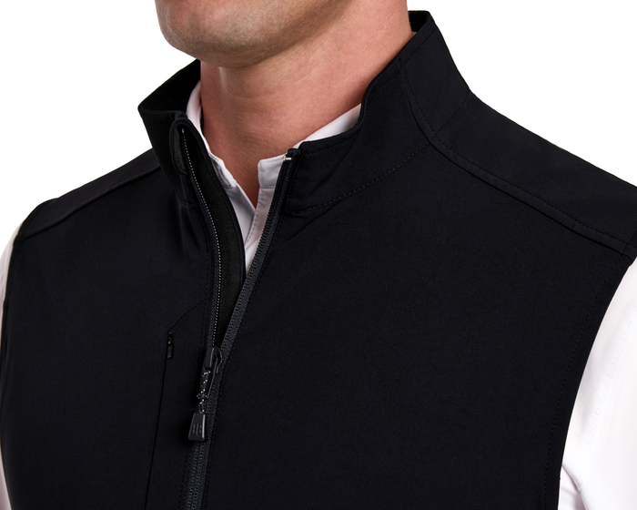 The Boyd Vest: Black - A sleek, zip-front sleeveless vest with a stand-up collar, designed for windproof and water-resistant performance, worn over a white collared shirt.
