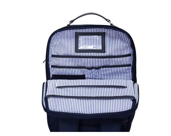 The Broughton Backpack: Navy Ballistic - Navy Embroidery, showing interior organization with pinstripe lining, ID window, zippered pockets, pen slots, and main compartment.