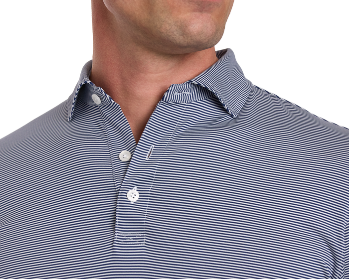 The Burke Shirt: Navy & White, slim-fit, long-sleeved polo with fine stripes, UPF 50+ protection, moisture-wicking, lightweight fabric, classic collar, two-button placket fastened.