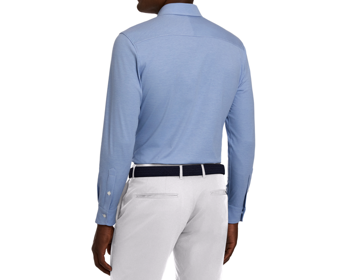 Back view of The Cullinane Shirt: Heathered Maidstone Blue, tucked into light trousers with a dark woven belt, showcasing yoke and buttoned cuffs.
