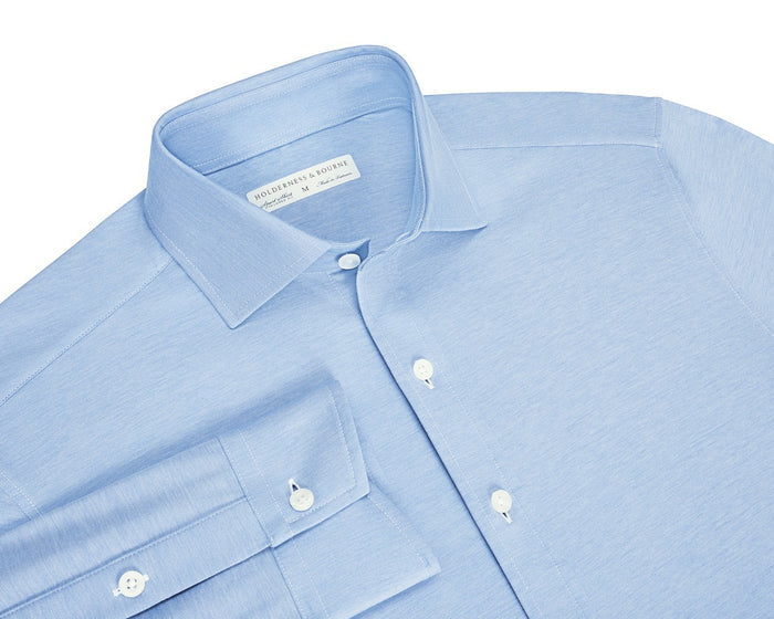 The Cullinane Shirt: Heathered Vista Blue, a light-blue button-front dress shirt, features a structured spread collar, white buttons, and super-soft cotton-blend performance pique.