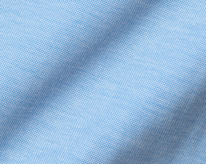The Cullinane Shirt: Heathered Vista Blue features a light-blue knit fabric with a small mesh pattern, offering comfort, stretch, and UPF 30+ protection.