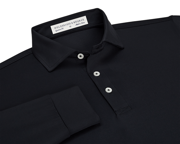 The Farrell Shirt: Black, features a long-sleeve polo design with light buttons, a spread collar, and Holderness & Bourne label, offering comfort and moisture wicking.