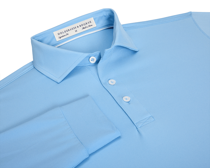 The Farrell Shirt: Vista Blue, a light-blue long-sleeve polo with a three-button placket, pointed collar, and contrast collar band piping, offers comfort and performance.