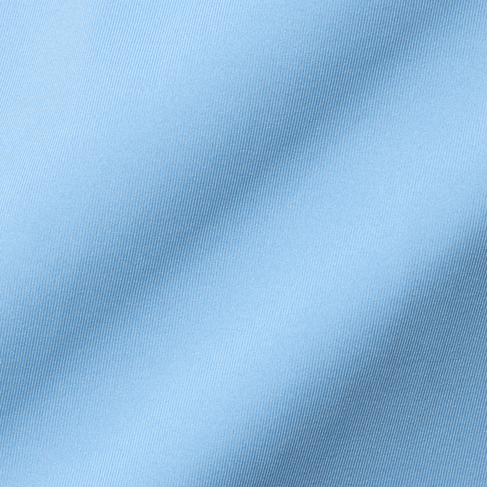 The Farrell Shirt: Vista Blue features a close-up of light blue twill weave fabric with fine diagonal ribs, highlighting its soft, draped texture.