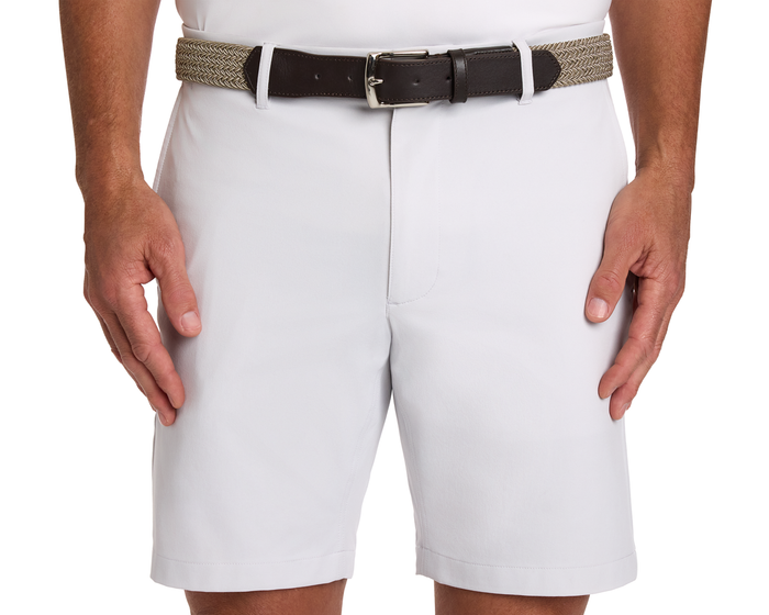 The Fischer Belt: Dune & Fescue Microstripe on white shorts, featuring a braided tan section and dark brown leather buckle, worn with hands at sides.