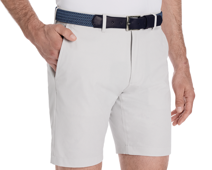 The Fischer Belt: Navy & Slate Microstripe with navy leather, shown around off-white shorts, highlighting its sleek design and premium stretch woven material from Italy.