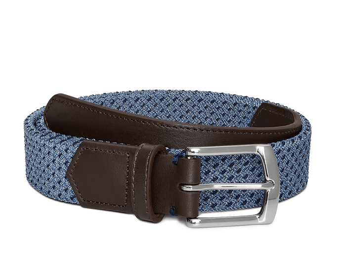 The Fischer Belt: Slate & Navy Basketweave features a blue braided strap, dark brown leather trim, and a shiny silver-tone metal buckle.