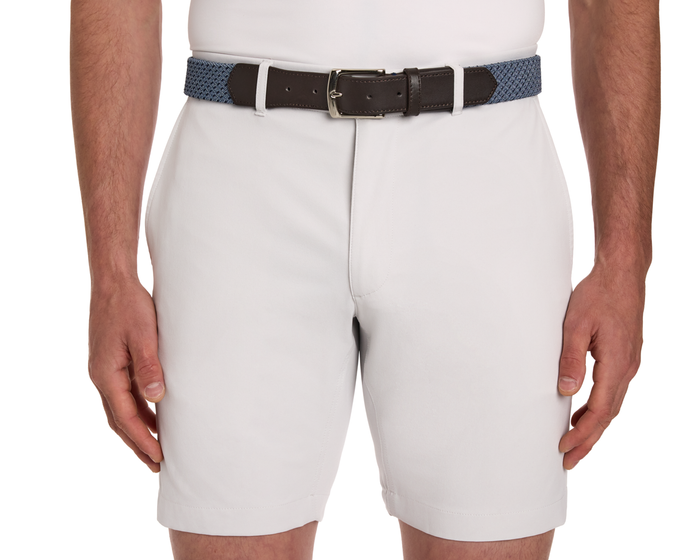 The Fischer Belt: Slate & Navy Basketweave shown on a model wearing light shorts, featuring a blue woven design with brown leather ends and a silver buckle.
