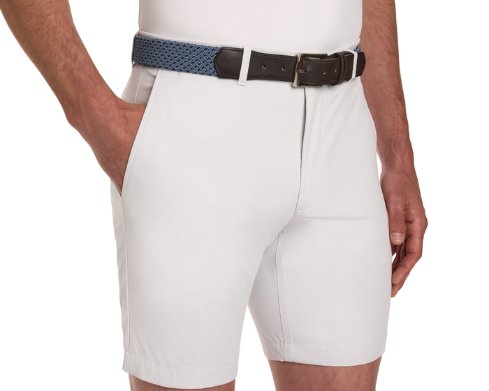 The Fischer Belt: Slate & Navy Basketweave, shown on shorts, features a denim-blue woven design with dark brown leather trim at the buckle.