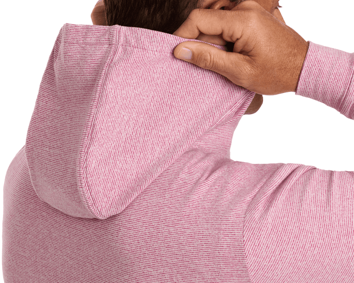 Back view of person adjusting the hood of The Hamilton Hoodie: Heathered Cabernet & White, showcasing its fine-striped pattern and relaxed fit.