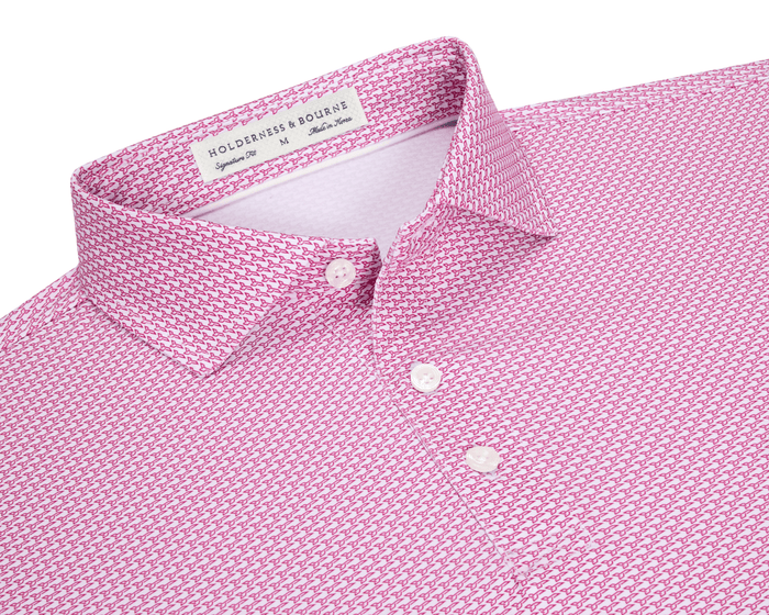 The Hanover Shirt: Cabernet, showing a close-up of the collar and placket with mother-of-pearl buttons, features a pink geometric jet pattern and label details.