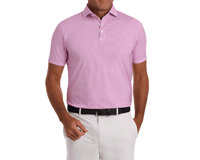 The Hanover Shirt: Cabernet, a short-sleeve polo with a geometric pattern, shown tucked into white trousers, featuring a spread collar and performance fabric.