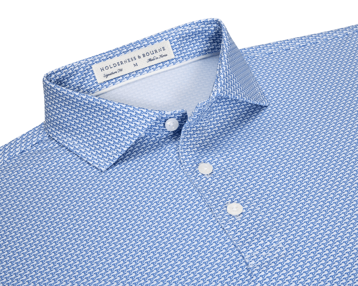 The Hanover Shirt: Maidstone Blue, a slim-fit men's button-down with spread collar, features a blue geometric pattern on white, offering comfort and sun protection.