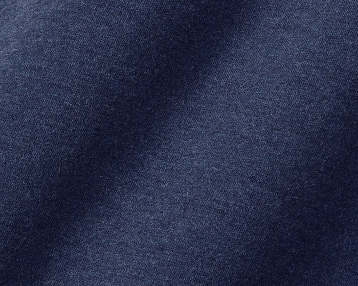 Close-up of The Harper Quarter-Zip: Heathered Atlantic, showcasing dark blue textile with visible fiber texture and soft, slightly folded surface, emphasizing comfort and style.