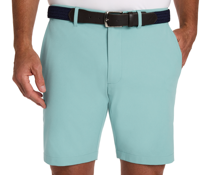 The Harwood Short: Cascade Green, worn with a navy braided belt, features slanted pockets and a comfortable fit, ideal for golfing versatility.