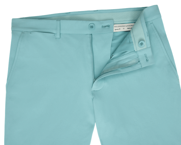 The Harwood Short: Cascade Green, featuring a partially open waistband, zip-fly, and inner label. Designed with built-in stretch, non-slip waistband, and ball-marker pocket.