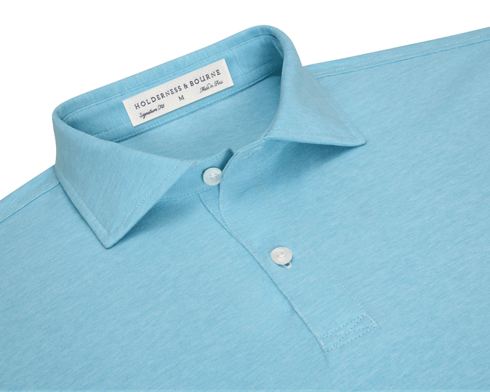 The Hatcher Shirt: Harbor & White features a folded collar, two white buttons, and a label indicating its signature fit and Peruvian cotton craftsmanship.