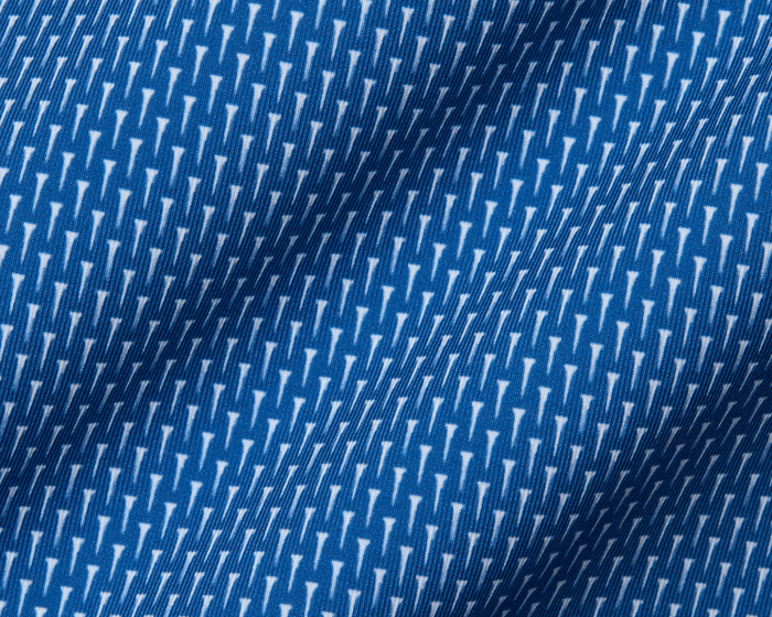 Close-up of The Hicks Shirt: Maidstone Blue, featuring a blue jersey fabric with white geometric motifs, showcasing its soft texture and structured collar.