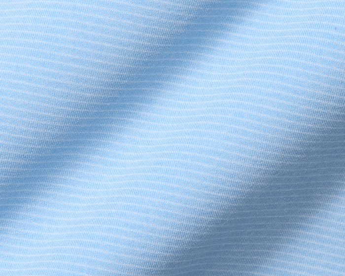 Close-up of The Holland Shirt: Heathered Vista Blue, showcasing its light-blue knit fabric with fine horizontal stripes and visible texture, emphasizing its sophisticated design.