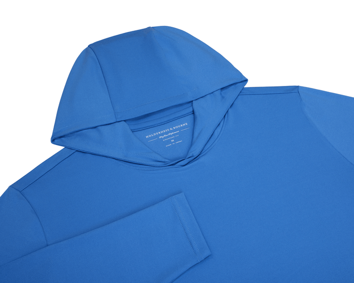 The Jackson Hoodie: Horizon Blue flat-lay showing its hood, long sleeves, and crew-neck, crafted from soft, lightweight performance fabric without drawstrings or pouches.
