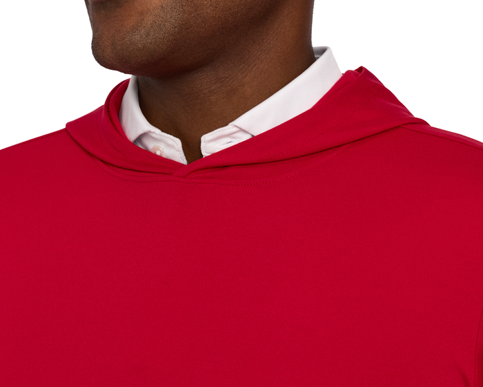Close-up of a person wearing The Jackson Hoodie: Liberty, showcasing its streamlined design and soft performance fabric over a white collared shirt.