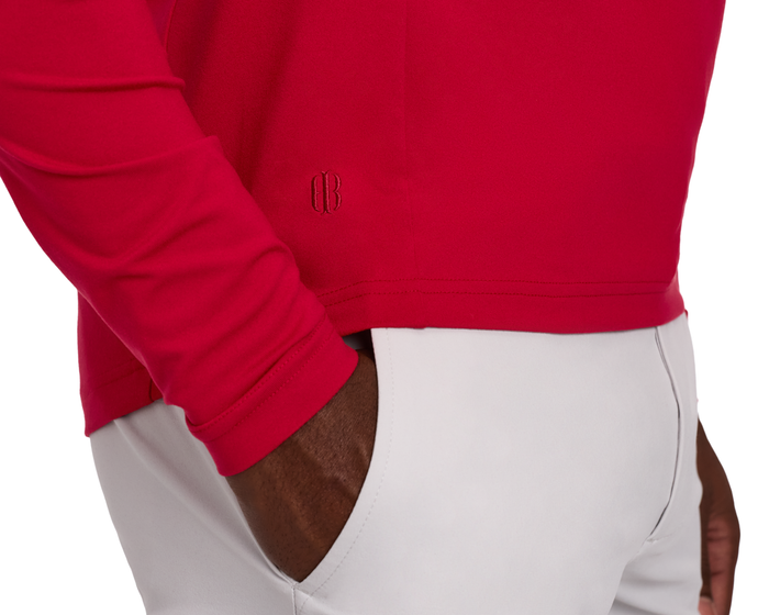 Close-up of a person wearing The Jackson Hoodie: Liberty, showcasing its streamlined, lightweight design and tonal embroidered logo, with a hand in a pocket.