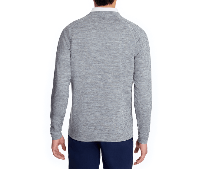 The Laidlay Crewneck: Heathered Gray, shown from the back, highlights its soft, stretchy fabric and modern fit, worn with navy pants against a simple backdrop.