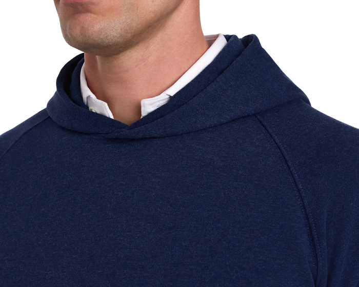 The Lawson Hoodie: Heathered Atlantic, shown layered over a white collared shirt, features a sleek design without drawstrings, perfect for versatile comfort.