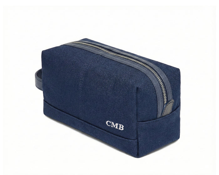 The Littler Dopp Kit: Navy Ballistic - White Embroidery, featuring a navy-blue canvas, top metal zipper, leather pull, side handle, and embroidered initials “CMB”.