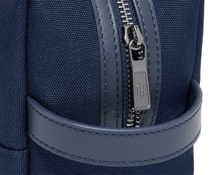 The Littler Dopp Kit: Navy Ballistic - White Embroidery, features a metal zipper, leather trim, and textured fabric, ideal for travel with a water-resistant interior.