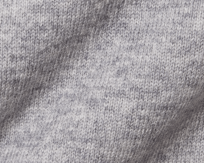 The Logan Hoodie Sweater: Heathered Gray, showcasing a close-up of its marled knit pattern with interlocking loops, highlighting the ribbed hem and cuffs.