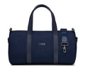 The Marston Banker Bag: Navy Ballistic - Slate Blue Embroidery, features a navy-blue canvas, leather-trimmed handles, shoulder strap, monogram CMB, and silver-tone clasp.