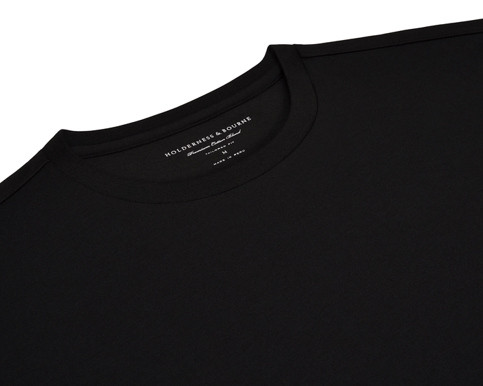The Mason T-Shirt: Black, features a plain crew-neck design with a visible Holderness & Bourne label, highlighting its tailored fit and premium cotton blend.