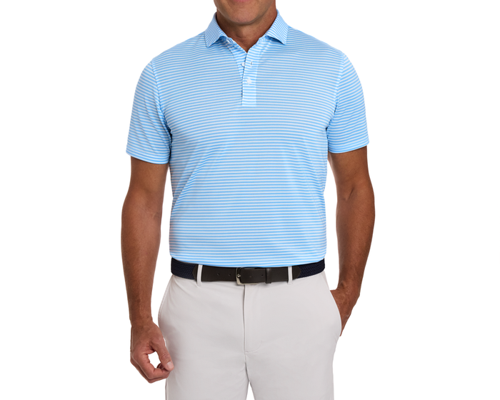 The Maxwell Shirt: Vista Blue & White, a striped polo with a structured collar, tucked into light trousers, featuring stretch pique for comfort and moisture-wicking.