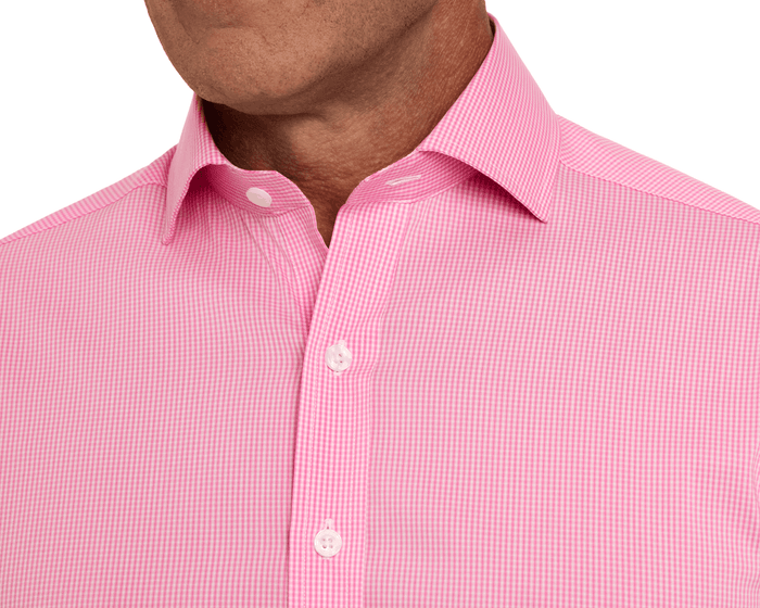 The McAllister Shirt: Belmont—a pink gingham dress shirt with a pointed collar, white buttons, and breathable, wrinkle-resistant fabric for polished comfort.