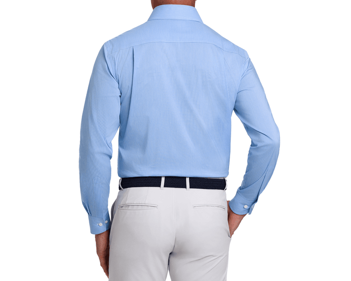 Back view of The McAllister Shirt: Horizon Blue, showcasing its checked pattern, structured spread collar, and comfortable fit, tucked into light gray trousers.