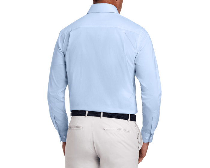 Back view of The McAllister Shirt: Vista Blue, a light-blue, long-sleeve, button-down shirt tucked into beige trousers, highlighting its crisp, breathable fabric and structured collar.