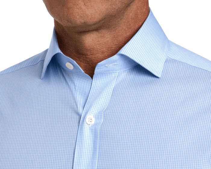 The McAllister Shirt: Vista Blue features a crisp spread collar and open top button, showcasing its breathable, stretch micro gingham fabric for all-day comfort.