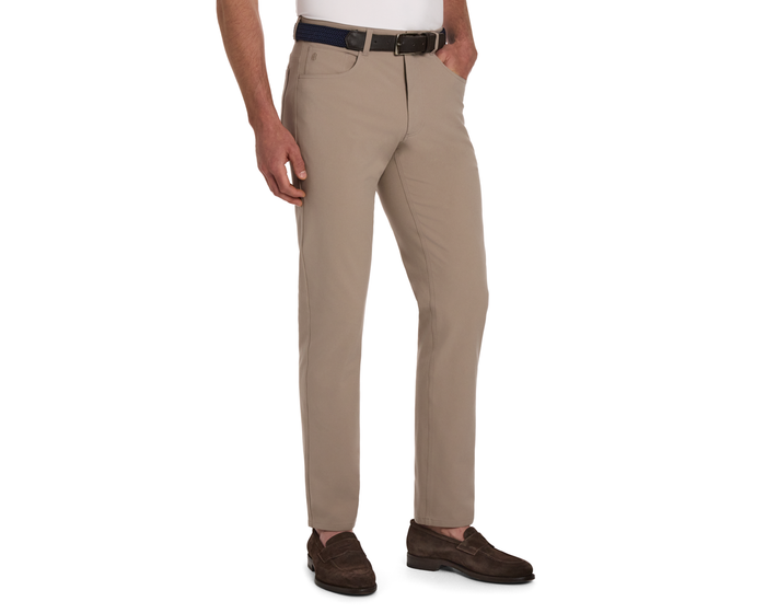 The McDaniel 5 Pocket Pant: Fescue, modeled with a braided navy belt and brown suede loafers, offers wrinkle-resistant, water-repellent, eco-friendly fabric with four-way stretch.