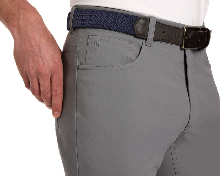 The McDaniel 5 Pocket Pant: Light Gray, showcasing front pocket detail, side seam, woven navy belt, and white shirt, emphasizing wrinkle-resistant, quick-dry, eco-friendly performance fabric.
