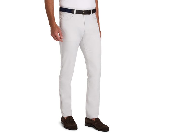 The McDaniel 5 Pocket Pant: Stone showcased in a slim-fit style with a dark woven belt, paired with a white shirt and dark brown loafers.