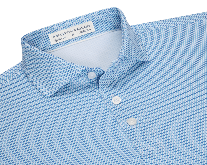 The Norman Shirt: Harbor & Maidstone Blue, a light-blue polo with subtle dark blue geometric pattern, classic collar, and three-button placket, featuring UPF 50+ protection.