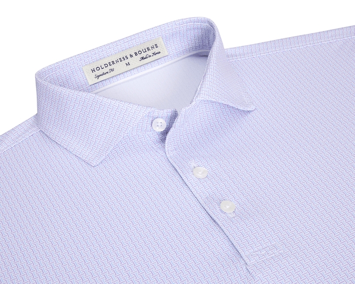 The Norwood Shirt: Vista Blue & Tudor features a folded, light lavender geometric pattern, spread collar, and white buttons, offering stylish versatility and comfort.