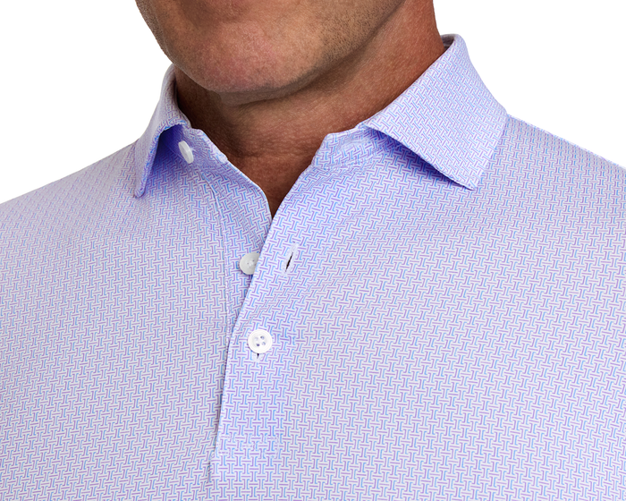 The Norwood Shirt: Vista Blue & Tudor features a geometric pattern, pointed collar, and white buttons, highlighting its sophisticated design and performance fabric.