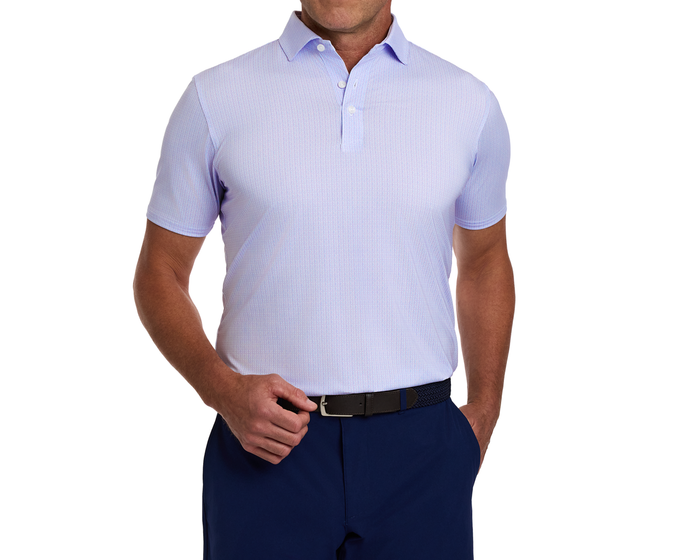 The Norwood Shirt: Vista Blue & Tudor features a geometric basketweave pattern, worn tucked into navy trousers, showcasing its structured collar and performance fabric.